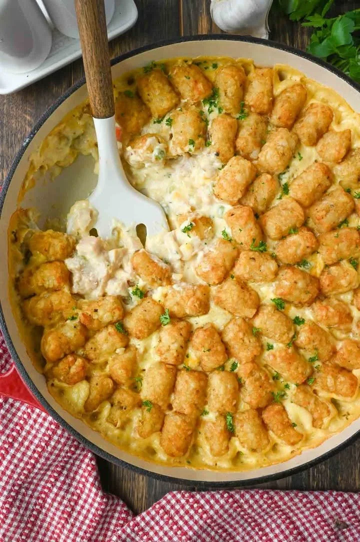 Tater Tot Chicken Casserole topped with crispy tater tots and served in a dish.