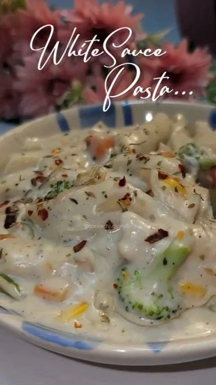 White Sauce Pasta Delicious bowl of white sauce pasta topped with herbs and cheese