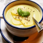 home Bowl of lemony artichoke soup garnished with herbs