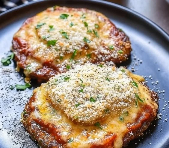 Delicious Portobello Mushroom Parmesan served with herbs and cheese