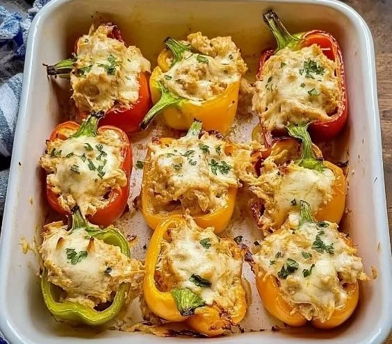 Creamy chicken stuffed peppers with herbs and spices, baked and ready to serve.