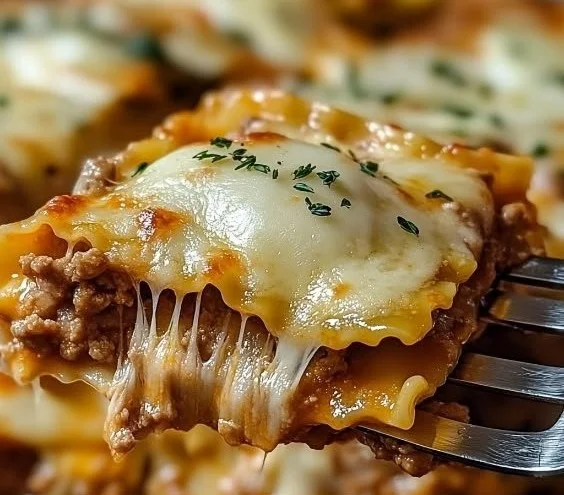 Delicious Million Dollar Ravioli Casserole topped with cheese and herbs.