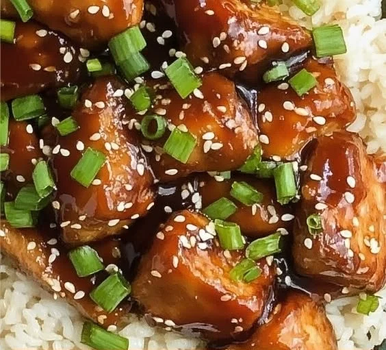 Delicious Slow Cooker Asian Sesame Chicken served with rice and vegetables
