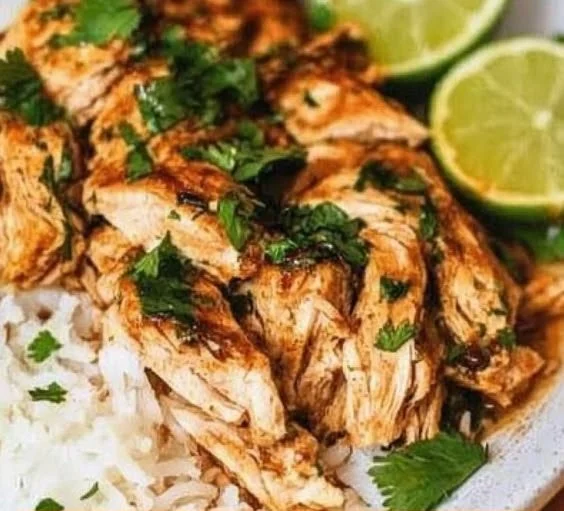 Slow cooker cilantro lime chicken dish garnished with fresh herbs