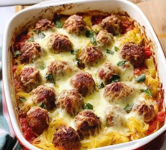 Delicious spaghetti squash meatball casserole topped with melted cheese.