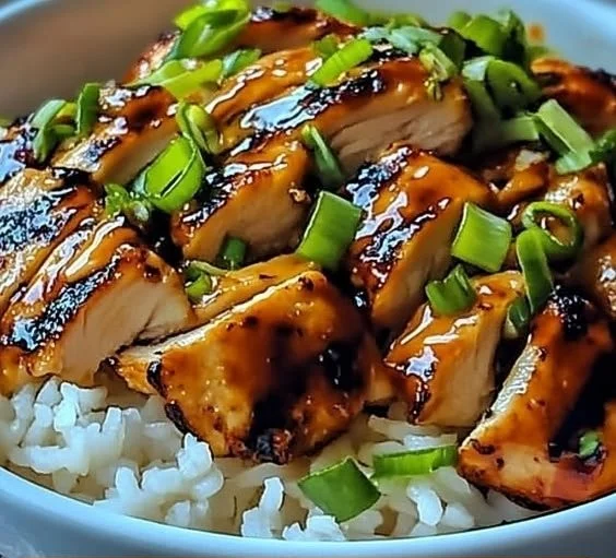 Plate of Spicy Maple Chicken with coconut rice, garnished and ready to serve.